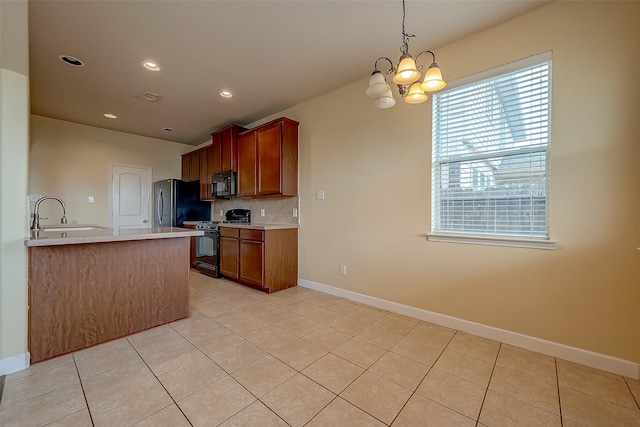 kitchen featuring light tile patterned floors, tasteful backsplash, black appliances, and a chandelier