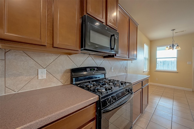 kitchen with black appliances, brown cabinetry, visible vents, and backsplash