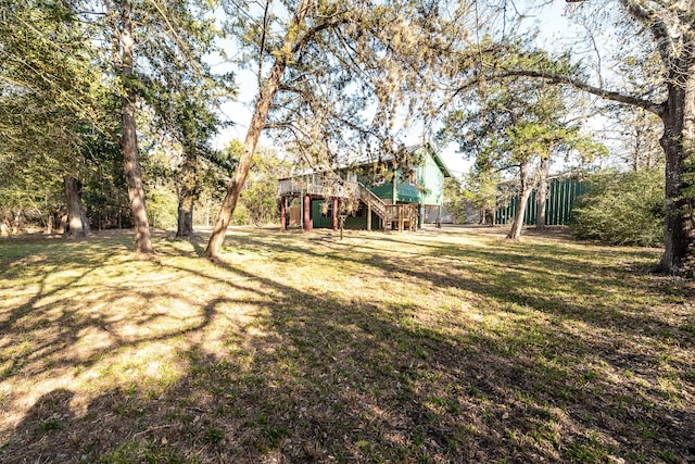 view of yard featuring a deck and stairway