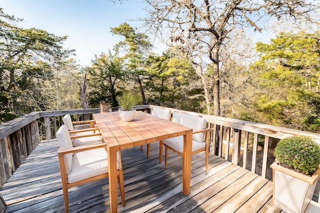 wooden terrace with outdoor dining area