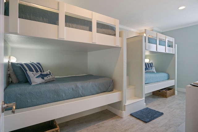 bedroom featuring baseboards, ornamental molding, wood finished floors, and recessed lighting