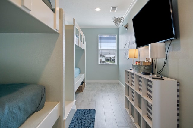 interior space featuring baseboards, visible vents, and crown molding