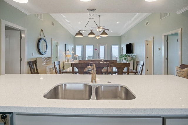 kitchen with open floor plan, ornamental molding, a sink, and visible vents