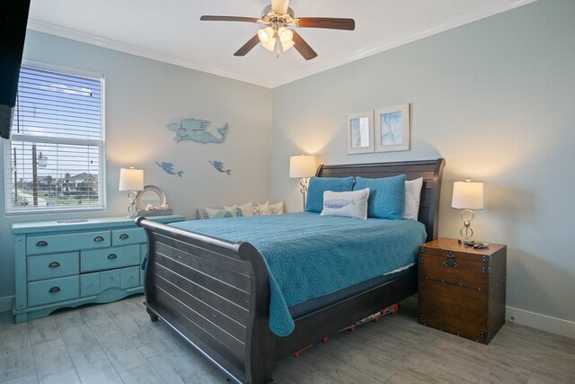 bedroom featuring ceiling fan, ornamental molding, light wood-type flooring, and baseboards