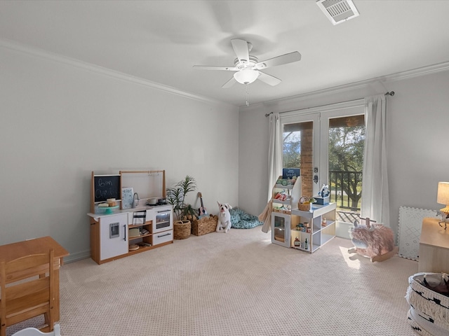 rec room featuring visible vents, a ceiling fan, french doors, carpet flooring, and crown molding