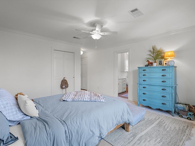 bedroom featuring ensuite bathroom, light carpet, a ceiling fan, visible vents, and crown molding