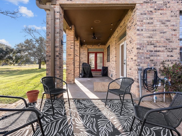 view of patio featuring a ceiling fan and french doors