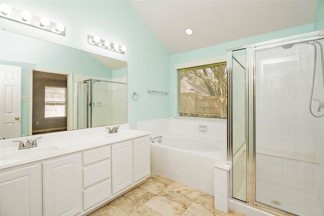 bathroom featuring a sink, a garden tub, a stall shower, and vaulted ceiling