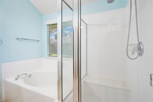 bathroom featuring a shower stall and a garden tub