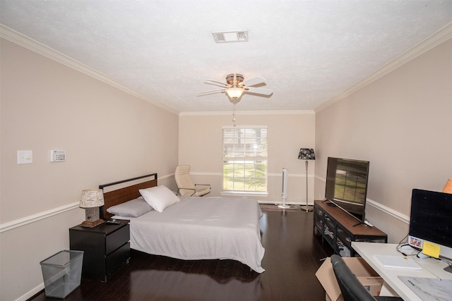 bedroom with ornamental molding, visible vents, a textured ceiling, and wood finished floors