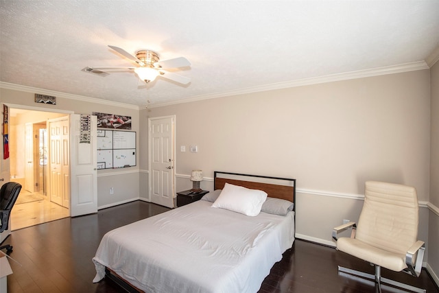 bedroom with crown molding, visible vents, ceiling fan, and wood finished floors