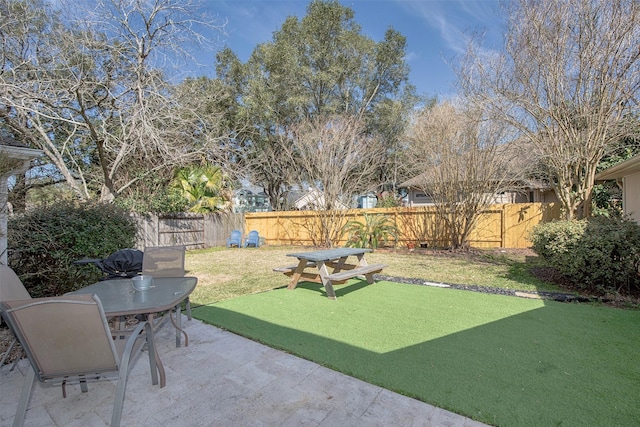 view of yard featuring a patio area and a fenced backyard