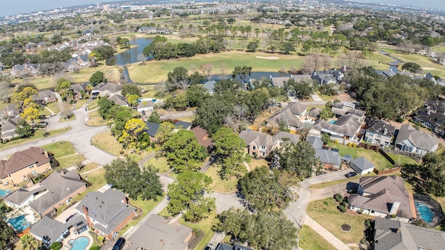 drone / aerial view with golf course view, a water view, and a residential view