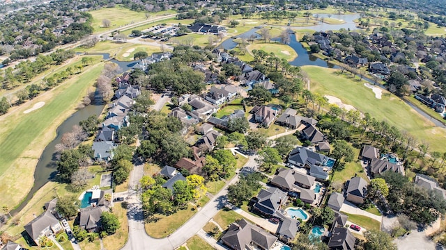 bird's eye view featuring golf course view, a water view, and a residential view