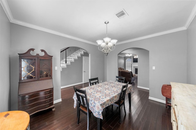 718 S Diamondhead Blvd, Crosby, TX 77532 - dining room featuring arched walkways, a chandelier, crown molding, dark wood finished floors, and stairs