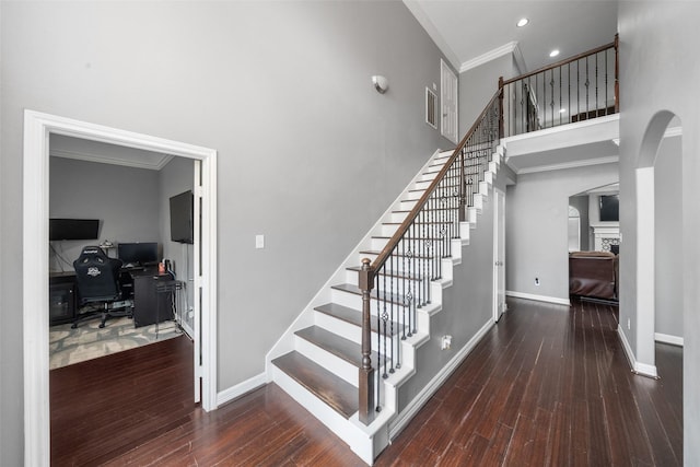718 S Diamondhead Blvd, Crosby, TX 77532 - stairs with ornamental molding, a towering ceiling, arched walkways, wood finished floors, and recessed lighting