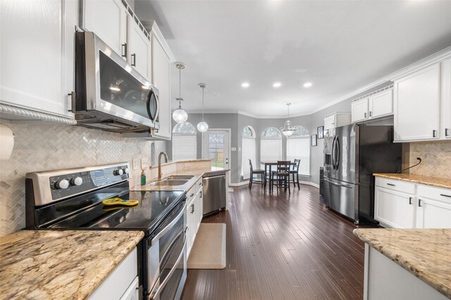 718 S Diamondhead Blvd, Crosby, TX 77532 - kitchen featuring appliances with stainless steel finishes, white cabinets, backsplash, light stone counters, and recessed lighting