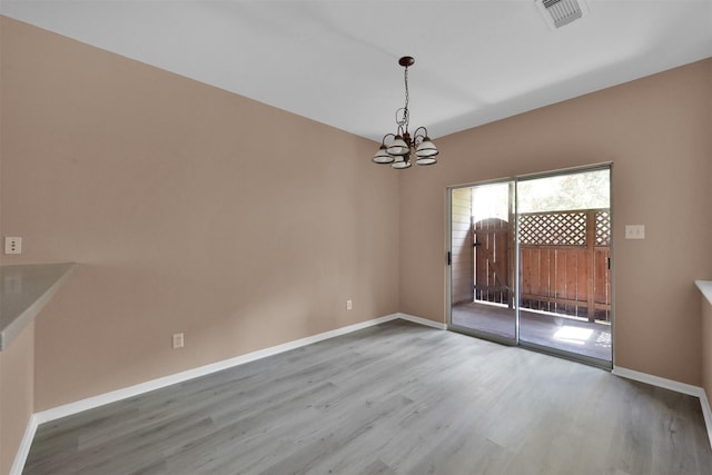 33 Stone Creek Pl, The Woodlands, TX 77382 - spare room with a chandelier, wood finished floors, and baseboards
