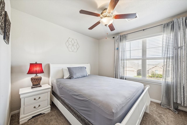 carpeted bedroom featuring baseboards and a ceiling fan