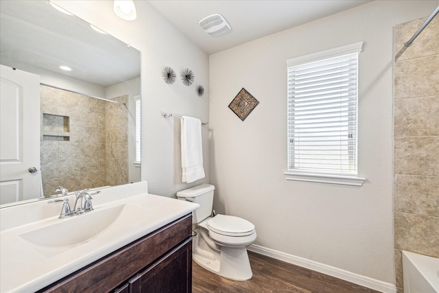 full bathroom featuring vanity, wood finished floors, visible vents, baseboards, and toilet