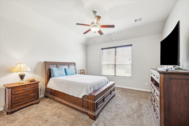 bedroom featuring visible vents, baseboards, light colored carpet, vaulted ceiling, and a ceiling fan