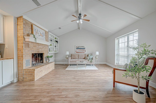 living room featuring a brick fireplace, visible vents, light wood-style flooring, and lofted ceiling with beams