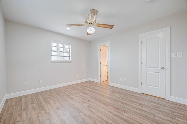 empty room with light wood-style flooring, baseboards, and a ceiling fan