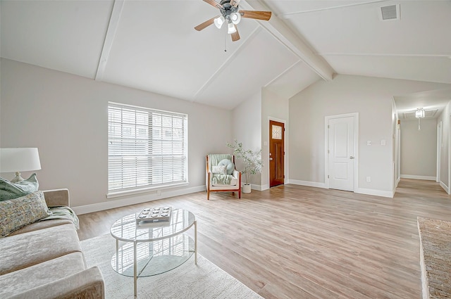 living room featuring visible vents, attic access, light wood-type flooring, beamed ceiling, and baseboards