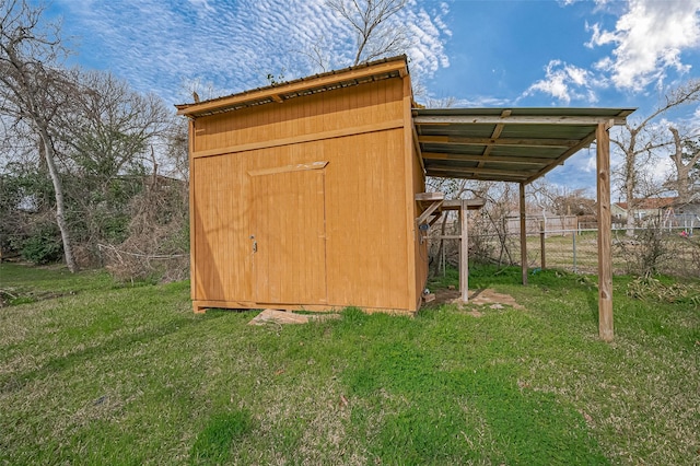 view of shed featuring fence