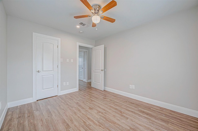 unfurnished bedroom with ceiling fan, light wood-type flooring, visible vents, and baseboards