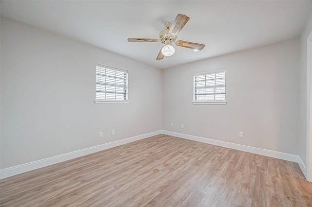 unfurnished room with plenty of natural light, light wood finished floors, baseboards, and ceiling fan