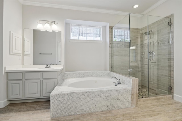 bathroom with a bath, a shower stall, crown molding, and vanity