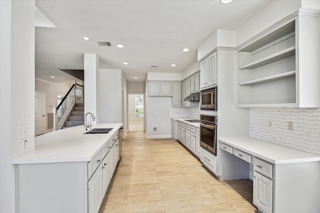 kitchen featuring stainless steel appliances, gray cabinets, a sink, and visible vents