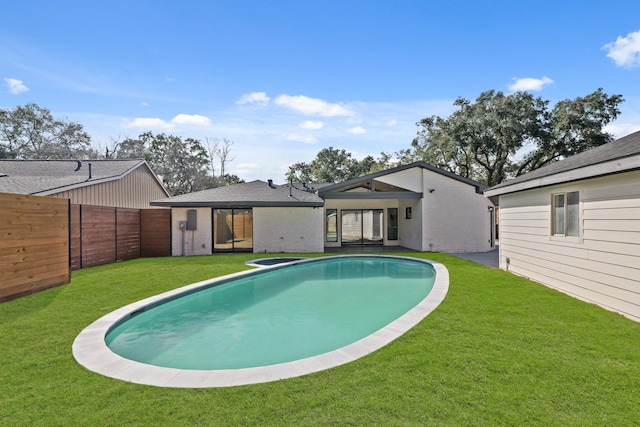 view of swimming pool featuring a fenced in pool, a fenced backyard, and a yard