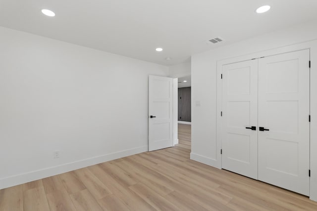 unfurnished bedroom with recessed lighting, light wood-type flooring, visible vents, and baseboards