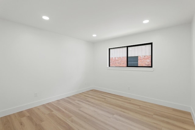 unfurnished room featuring recessed lighting, light wood-style flooring, and baseboards