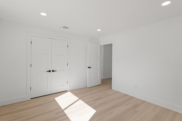 unfurnished bedroom featuring baseboards, light wood-style flooring, visible vents, and recessed lighting