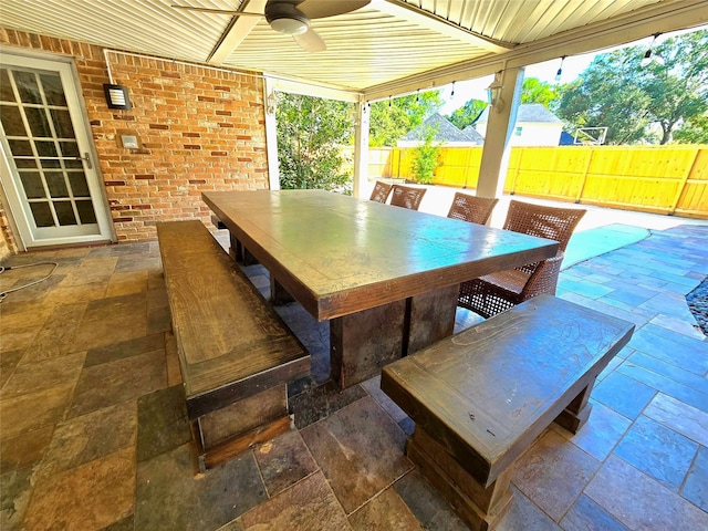 view of patio featuring ceiling fan, outdoor dining area, and fence private yard