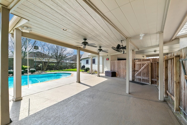 view of swimming pool featuring a patio area, a fenced in pool, a fenced backyard, and ceiling fan