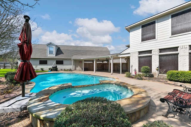 view of pool with a patio and a pool with connected hot tub