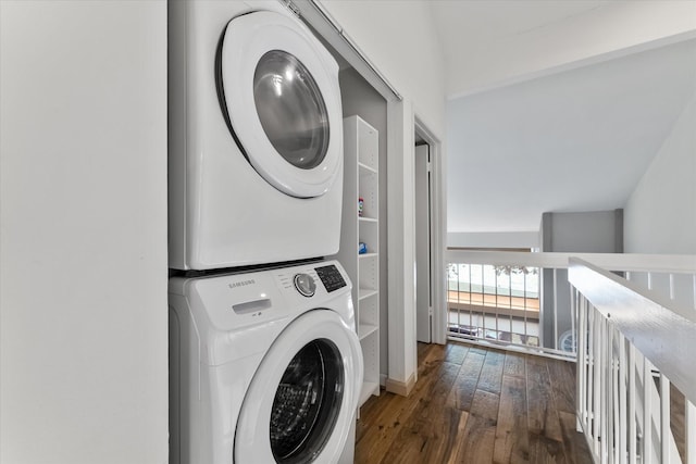 washroom with laundry area, hardwood / wood-style floors, and stacked washing maching and dryer