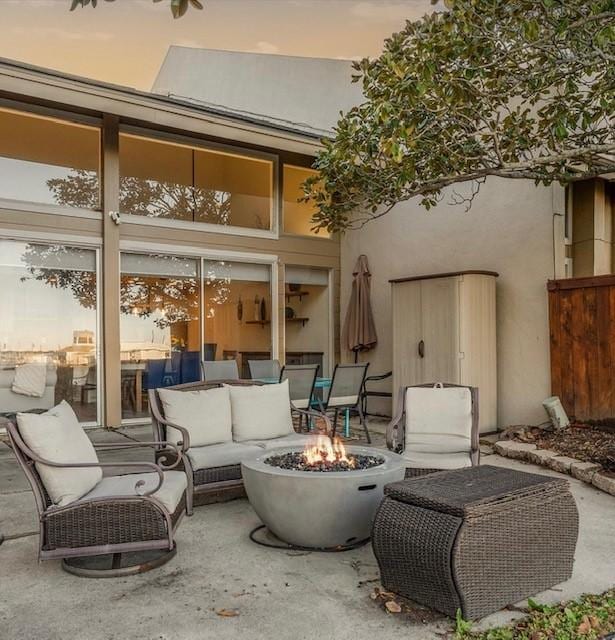 view of patio / terrace with an outdoor living space with a fire pit