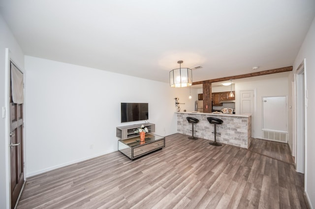 living area featuring light wood-type flooring and visible vents