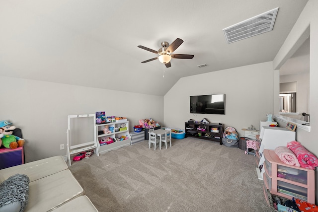 playroom featuring vaulted ceiling, carpet flooring, visible vents, and a ceiling fan