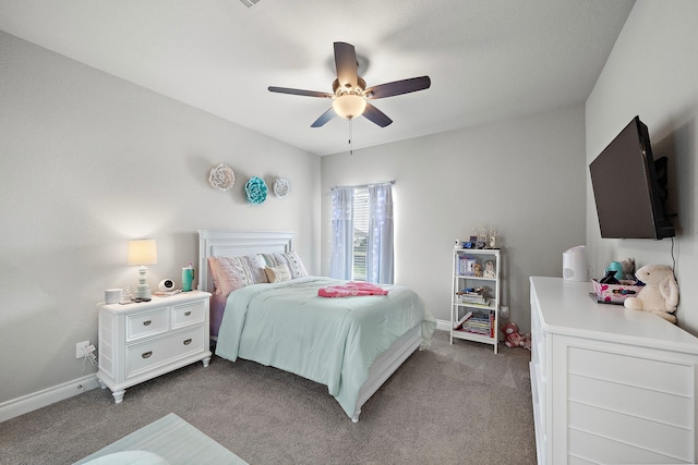 carpeted bedroom with ceiling fan and baseboards