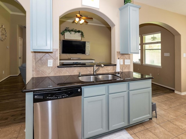 kitchen with ceiling fan, stainless steel dishwasher, a sink, and crown molding