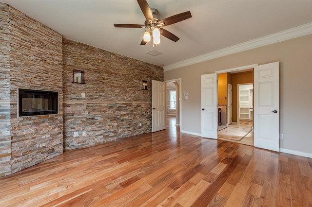 unfurnished room with a ceiling fan, ornamental molding, baseboards, and wood finished floors