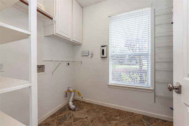 clothes washing area featuring washer hookup, cabinet space, baseboards, and electric dryer hookup