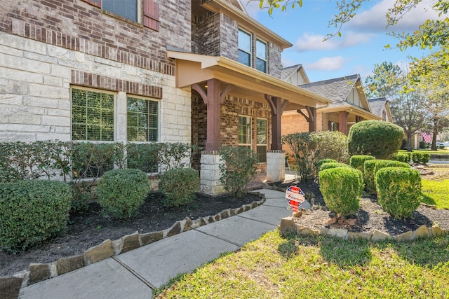 property entrance featuring brick siding