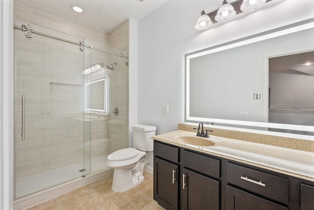 bathroom with a stall shower, vanity, and toilet